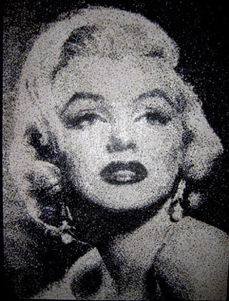 MARILYN MONROE
Hole Puch Dots (Aprox 99,000) on wood.
Size- 160cm by 122cm 
Completed December 2010
Marilyn was a commissioned piece of work. I really enjoyed doing another one in coloured dots to make a black and white image, as I had with Senna. This one allowed me to improve the technique, and get the blending of tone better than I had done in my first attempt. I was far more confident, including brighter colours, sure that they would still give a black and white \"look\" at the end. I wanted to keep this piece when it was completed but unfortunately a deposit had already been paid. It was the first piece that I have made where I didn't think I could do any better.
